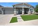 Charming single-story home with a gray exterior, stone accents, and a well-manicured lawn at 22728 E Camacho Rd, Queen Creek, AZ 85142