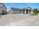 Attractive home with a spacious driveway, two-car garage, and meticulously maintained front yard at 22728 E Camacho Rd, Queen Creek, AZ 85142