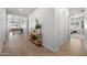 Inviting hallway with wood floors, stylish console table, and views to the living area at 22728 E Camacho Rd, Queen Creek, AZ 85142