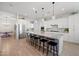 Bright, open kitchen with stainless steel appliances and large island for barstool seating at 22728 E Camacho Rd, Queen Creek, AZ 85142