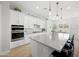 Spacious kitchen with an island, granite countertops, modern appliances and pendant lighting at 22728 E Camacho Rd, Queen Creek, AZ 85142
