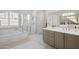 Bright main bathroom with a walk-in shower, soaking tub, neutral color palette, and ample counter space at 22728 E Camacho Rd, Queen Creek, AZ 85142