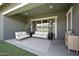 Inviting covered patio with comfortable seating, ceiling fans, and stylish decor at 22728 E Camacho Rd, Queen Creek, AZ 85142