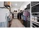 Well-organized walk-in closet with ample storage, shelving, and hanging space for clothes and accessories at 22728 E Camacho Rd, Queen Creek, AZ 85142