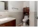 Modern bathroom featuring neutral-colored walls and cabinets, a stylish sink with a solid-surface countertop, and decorative wall texture at 2721 E Schiliro Cir, Phoenix, AZ 85032