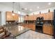 Well-equipped kitchen boasts stainless steel appliances, granite countertops, a mosaic backsplash, and bar stool seating at 2721 E Schiliro Cir, Phoenix, AZ 85032