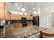 This well-equipped kitchen boasts stainless steel appliances, granite countertops, a mosaic backsplash and under cabinet lighting at 2721 E Schiliro Cir, Phoenix, AZ 85032