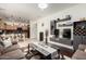 Open-concept living room showcasing modern decor, a sleek entertainment center, and hardwood floors that transition to a lovely kitchen at 2721 E Schiliro Cir, Phoenix, AZ 85032