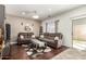 Comfortable living room features hardwood floors, plush seating, and abundant natural light from the sliding door to the backyard at 2721 E Schiliro Cir, Phoenix, AZ 85032