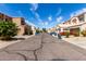 Street view of tan two story homes with white roofs and green landscaping on a sunny day at 2721 E Schiliro Cir, Phoenix, AZ 85032