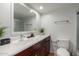 Bathroom with a white sink, wood cabinets, and a shower with sliding glass doors at 3601 W Tierra Buena Ln # 168, Phoenix, AZ 85053