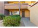 Exterior shot of condo showing door with small bushes, rock and walkway at 3601 W Tierra Buena Ln # 168, Phoenix, AZ 85053