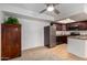 Open concept living space featuring carpeting, tile, stainless appliances and a dark wood kitchen at 3601 W Tierra Buena Ln # 168, Phoenix, AZ 85053