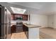 Bright kitchen with stainless steel appliances, tile floors, and skylight at 3601 W Tierra Buena Ln # 168, Phoenix, AZ 85053