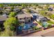 Aerial view showcases a well-maintained backyard with a pool, patio area, and vibrant greenery at 3901 E Packard Dr, Gilbert, AZ 85298