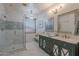 Bright bathroom with a marble shower, double sink vanity and chandelier at 3901 E Packard Dr, Gilbert, AZ 85298