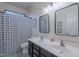 Bathroom with double sinks, patterned shower curtain, and tile floors at 3901 E Packard Dr, Gilbert, AZ 85298
