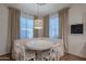 Charming breakfast nook featuring a round table, cushioned seating, and soft natural light from the large windows at 3901 E Packard Dr, Gilbert, AZ 85298