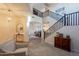 Grand foyer featuring soaring ceilings, a staircase, and elegant furnishings, creating a lasting first impression at 3901 E Packard Dr, Gilbert, AZ 85298