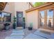 Charming front entrance with decorative wreath, potted plants, and 'Welcome' mats at 3901 E Packard Dr, Gilbert, AZ 85298