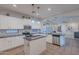 Bright kitchen with white cabinets, granite countertops, stainless steel appliances, and decorative backsplash at 3901 E Packard Dr, Gilbert, AZ 85298