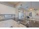 Well-appointed kitchen featuring a stainless steel sink, granite countertops, and ample natural light from the window at 3901 E Packard Dr, Gilbert, AZ 85298