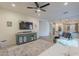 Open-concept living room with a sleek TV, comfortable seating, and a view into the kitchen, perfect for entertaining at 3901 E Packard Dr, Gilbert, AZ 85298