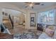 Charming living room with a view of the staircase, a vintage couch, and ample natural light at 3901 E Packard Dr, Gilbert, AZ 85298