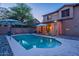 Backyard pool area featuring stylish umbrellas, privacy curtains, and professional stone landscaping at 3901 E Packard Dr, Gilbert, AZ 85298