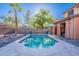 Refreshing pool with a stone surround, sun umbrellas, and a private backyard setting at 3901 E Packard Dr, Gilbert, AZ 85298