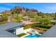 Stunning aerial view features a pool, lush landscaping, and mountain views at 4218 E Palo Verde Dr, Phoenix, AZ 85018