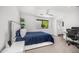 Bright bedroom with large window, modern ceiling fan, and convenient access to an ensuite bathroom at 4218 E Palo Verde Dr, Phoenix, AZ 85018