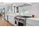 Modern kitchen with white cabinets, stainless steel appliances, and light wood floors at 4218 E Palo Verde Dr, Phoenix, AZ 85018