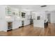 Modern kitchen with sleek white cabinetry, hardwood floors, and stainless steel appliances at 4218 E Palo Verde Dr, Phoenix, AZ 85018