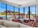 Bright living room with floor-to-ceiling windows and comfortable seating with views of the pool and mountains at 4218 E Palo Verde Dr, Phoenix, AZ 85018
