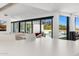 Bright living room with sliding glass doors opening to a pool and mountain view at 4218 E Palo Verde Dr, Phoenix, AZ 85018