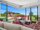 Bright living room with floor-to-ceiling windows and comfortable seating with views of the pool and mountains at 4218 E Palo Verde Dr, Phoenix, AZ 85018