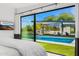 Main bedroom with floor-to-ceiling windows and a view of the pool at 4218 E Palo Verde Dr, Phoenix, AZ 85018