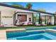 Inviting outdoor living space features a modern pool, covered seating area, and lush landscaping at 4218 E Palo Verde Dr, Phoenix, AZ 85018