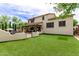 Lush backyard with artificial turf, outdoor kitchen, and covered patio at 42711 N 45Th Dr, Phoenix, AZ 85087