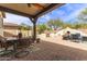 Open-air patio with dining and seating areas and well-maintained brick pavers at 42711 N 45Th Dr, Phoenix, AZ 85087
