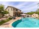 Aerial view of a backyard swimming pool with fountain, patio, and lush landscaping at 42711 N 45Th Dr, Phoenix, AZ 85087