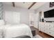 Bedroom has a rustic ceiling with wooden beams and a view into the en suite bathroom at 42711 N 45Th Dr, Phoenix, AZ 85087
