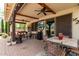 A spacious covered patio featuring a ceiling fan and comfortable seating at 42711 N 45Th Dr, Phoenix, AZ 85087