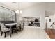 Bright dining room with tile floors, views of living spaces, and large windows at 42711 N 45Th Dr, Phoenix, AZ 85087