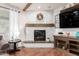 Close-up of a fireplace with marble tile and wood mantel with some decor accents at 42711 N 45Th Dr, Phoenix, AZ 85087