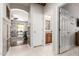 Hallway view of a living space with open sliding doors, tile floors, and access to a half-bathroom at 42711 N 45Th Dr, Phoenix, AZ 85087