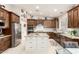 Spacious kitchen featuring stainless appliances, dark wood cabinetry, and granite countertops at 42711 N 45Th Dr, Phoenix, AZ 85087
