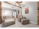 Finished living room features wooden beams, neutral paint, stylish decor, and plenty of seating at 42711 N 45Th Dr, Phoenix, AZ 85087