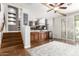 Spacious living room with hardwood floors, wet bar, and sliding glass doors for natural light at 42711 N 45Th Dr, Phoenix, AZ 85087